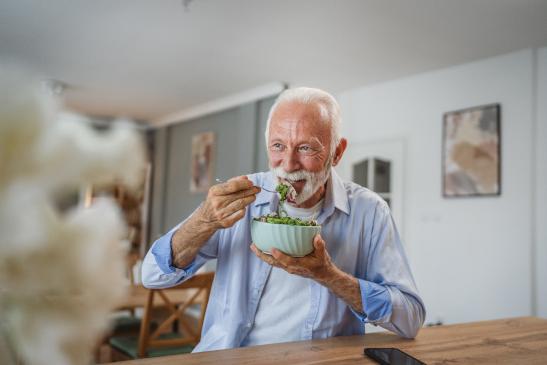 Älterer Herr isst einen Salat